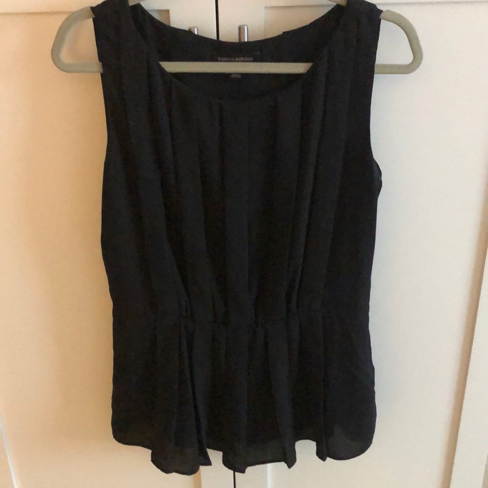 Pleated black sleeveless blouse